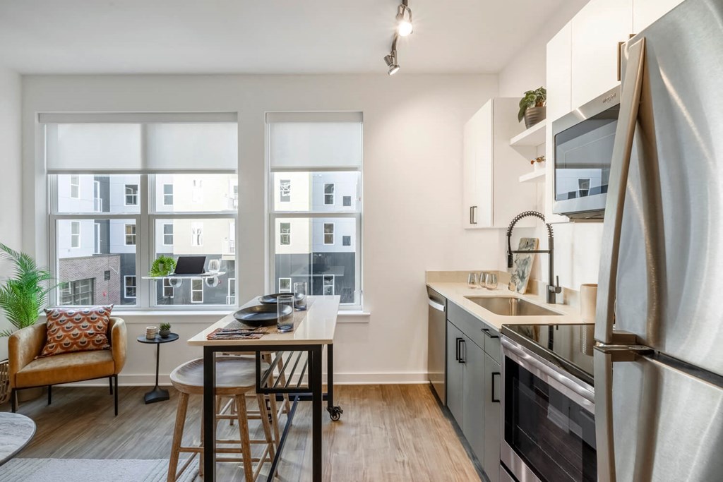 Model open kitchen and dining area with a large window