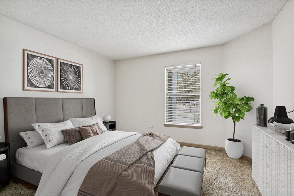 Model bedroom with a large bed at Retreat at Crosstown Apartments