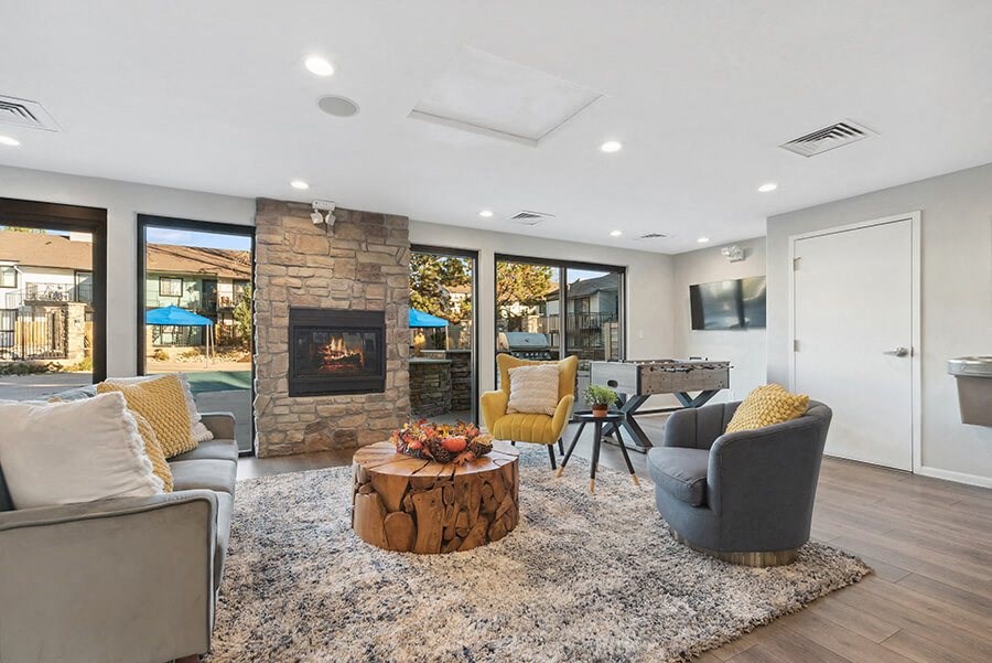 Community Clubhouse with Lounge Furniture and a Fireplace at Liberty Creek Apartments in Aurora, CO.