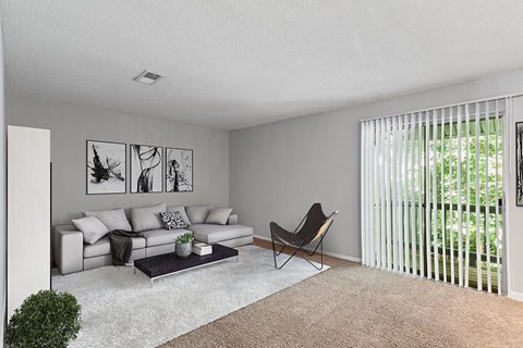 Model Living Room with Carpet and Patio Accessibility at Corners at 1700 Apartments in Atlanta, GA.