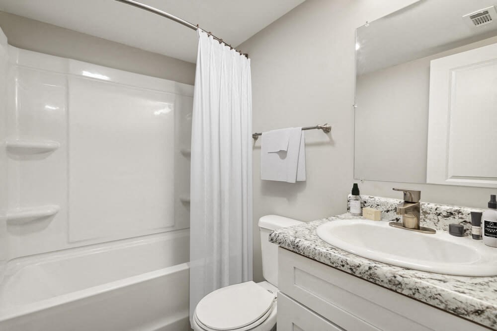 Model bathroom with a sink toilet and shower