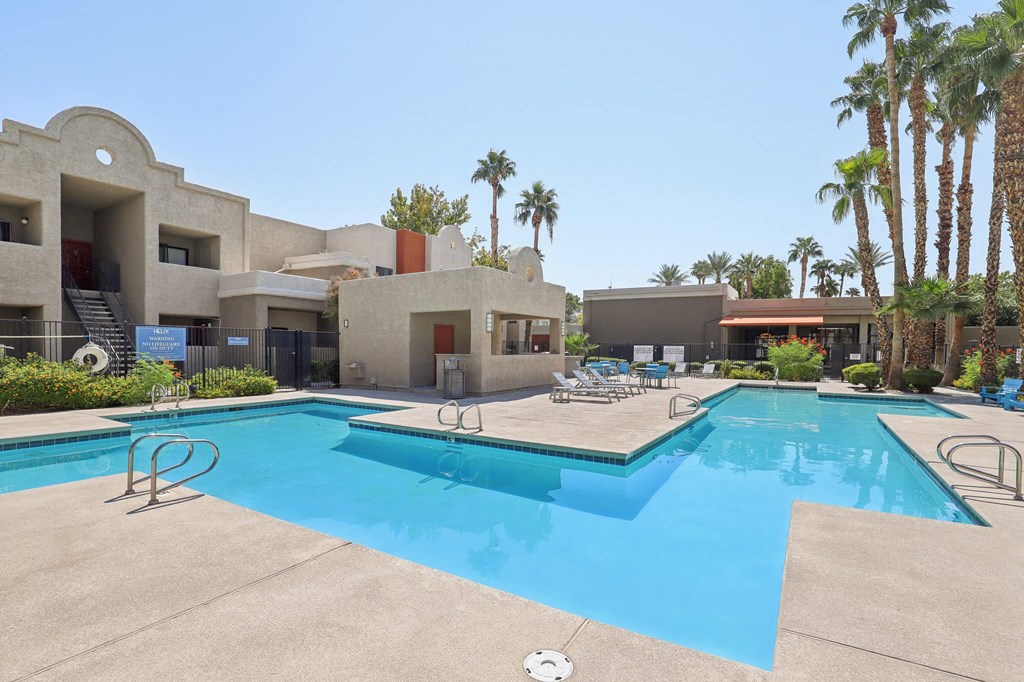 Community Swimming Pool with Pool Furniture at Helix Apartments located in Las Vegas, NV.