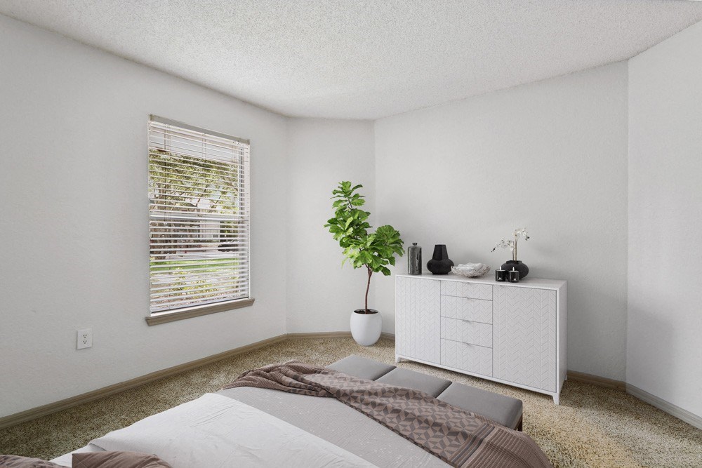 Model bedroom with carpeting at Retreat at Crosstown Apartments