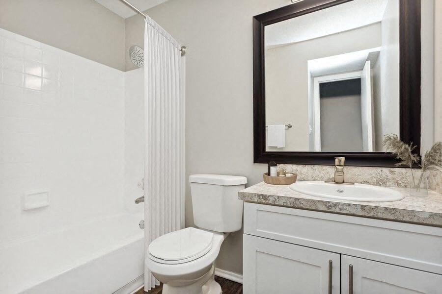 Model Bathroom with White Vanity at Caribbean Breeze Apartments in Tampa, FL.