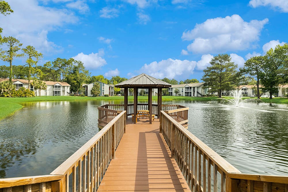 Gazebo at the end of a wooden dock overlooking a pond with a fountain at Vue at Baymeadows Apartments in Jacksonville, Florida