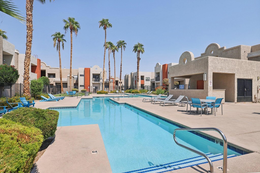 Community Swimming Pool with Pool Furniture at Helix Apartments located in Las Vegas, NV.