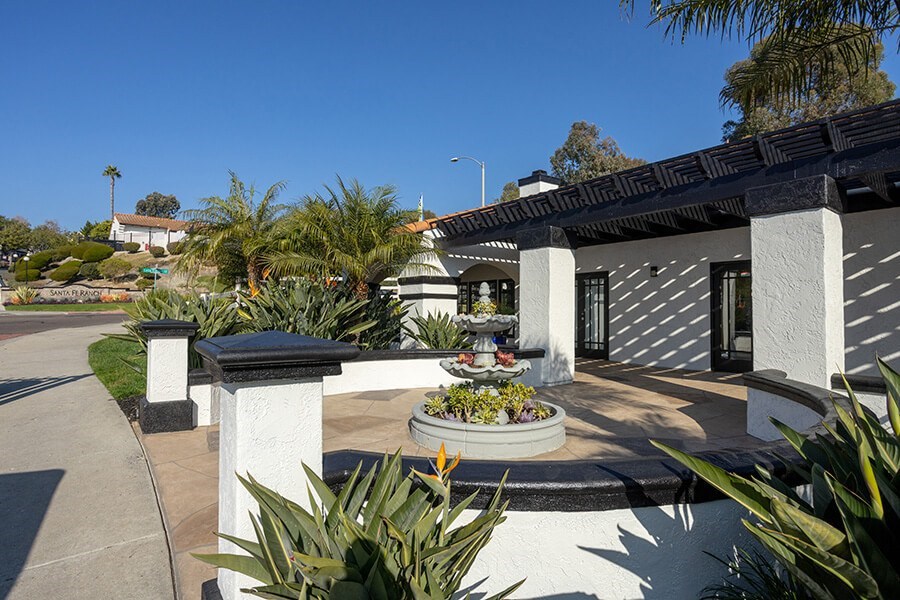 Exterior Community Building with Fountain and Landscape at Santa Fe Ranch Apartments located in Carlsbad, CA.