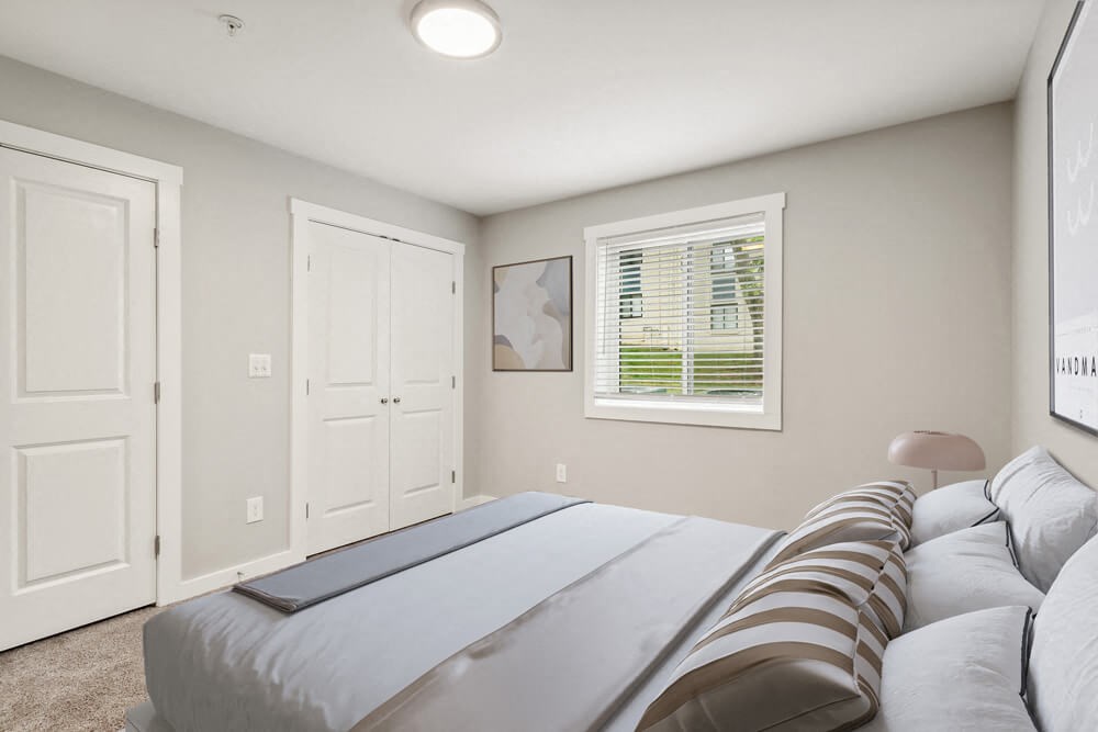 Model bedroom with a bed and a window