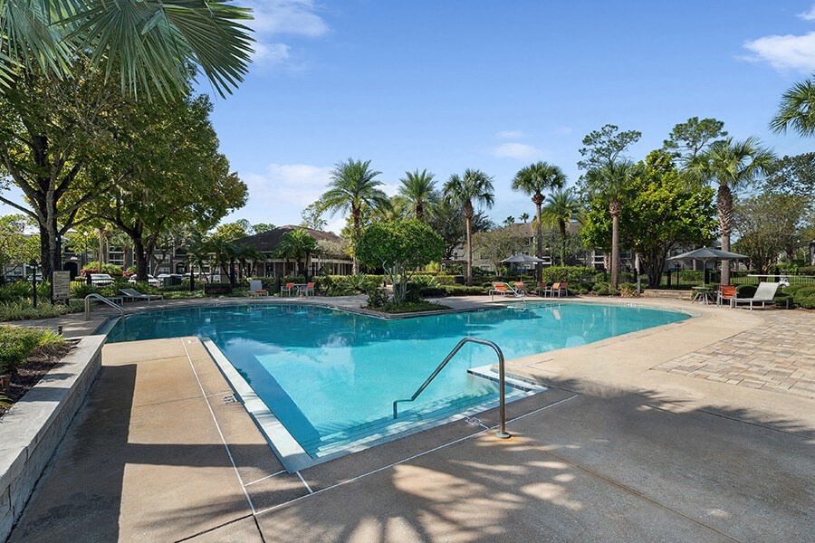Community Swimming Pool with Pool Furniture at Fountains Lee Vista Apartments in Orlando, FL.