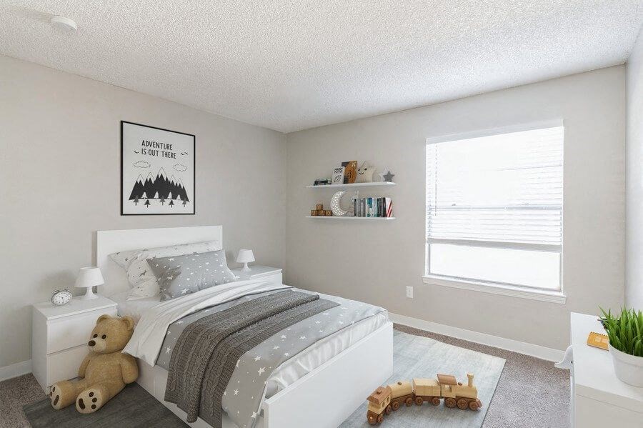 Model Bedroom with Carpet and Window View at Indigo Park Apartments in Albuquerque, NM.