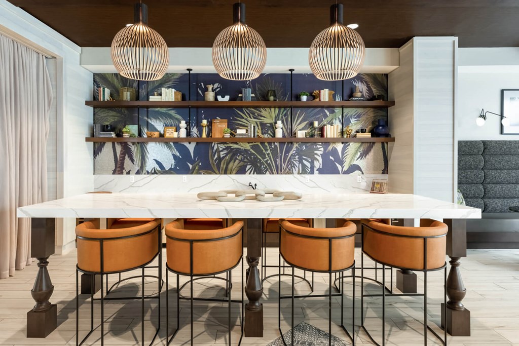 a kitchen with a marble counter top and chairs