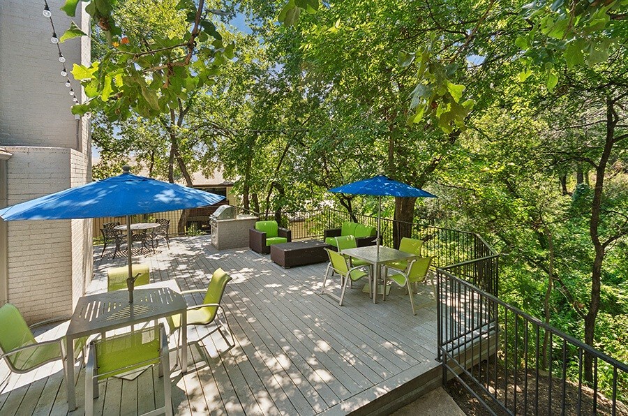 Outdoor Patio with Lounge Furniture & BBQ Grills at Woodcreek Apartments located in Arlington, TX.