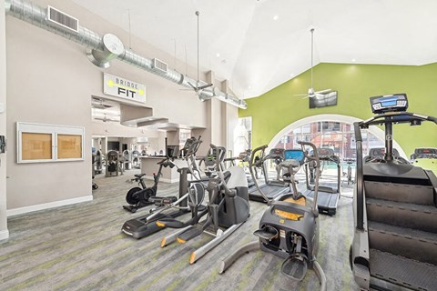 Apartments in Lewisville, TX with In-Unit Washer and Dryer - Chapel Hill - Spacious Fitness Center With Treadmills, Ellipticals, Strength Machines, High Ceiling Ductwork, And Large Arched Windows