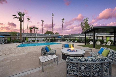 Outdoor Fire Pit Area and Swimming Pool with Lounge Furniture at Arcadia on 49th Apartments located in Phoenix, AZ.