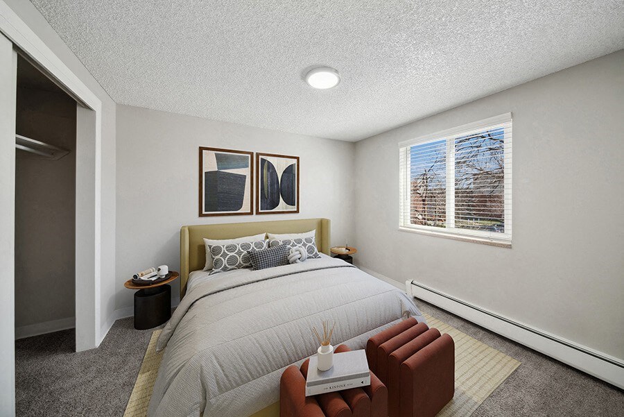 Model Bedroom with Carpet and Closet at Esprit at Cherry Creek Apartments in Glendale, CO.