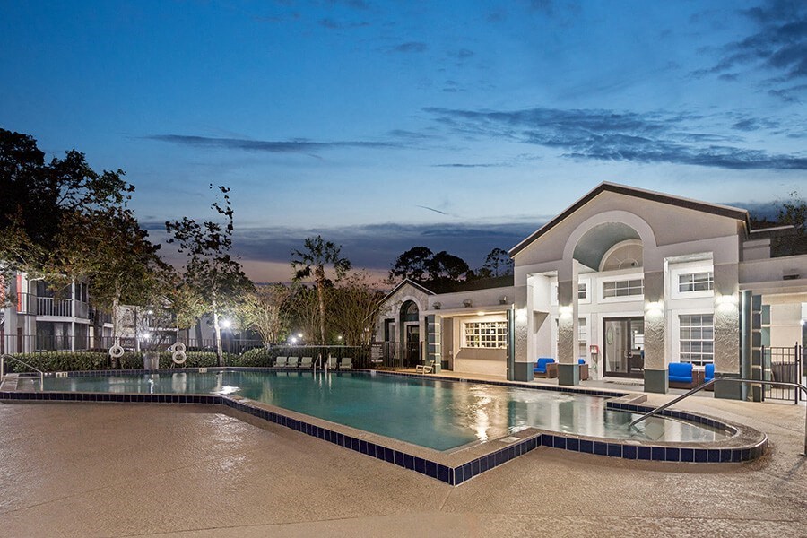 Community Swimming Pool with Pool Furniture at Vue at Baymeadows Apartments in Jacksonville, FL.