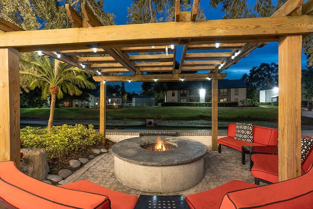 Outdoor BBQ Area with Furniture at Carrollwood Station Apartments in Tampa, FL.