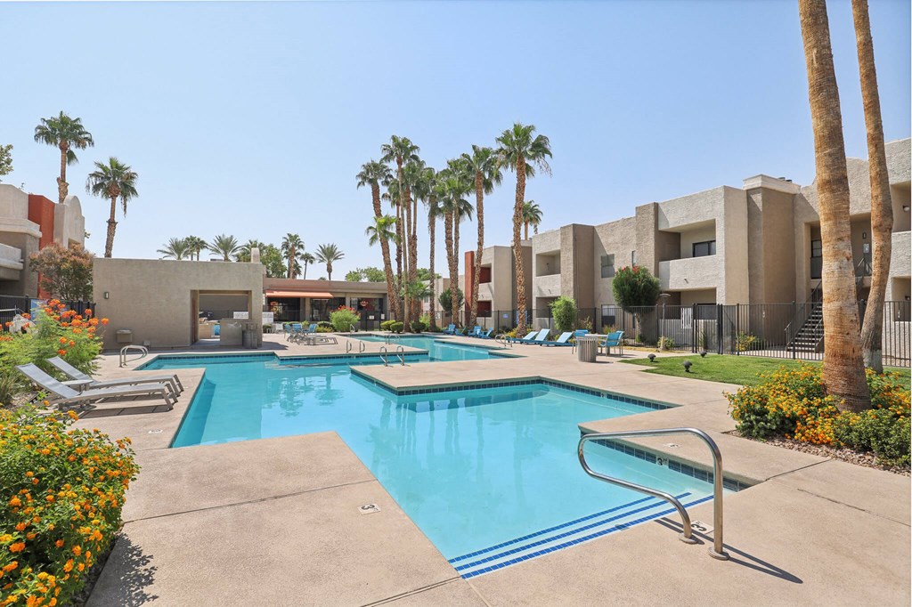 Community Swimming Pool with Pool Furniture at Helix Apartments located in Las Vegas, NV.