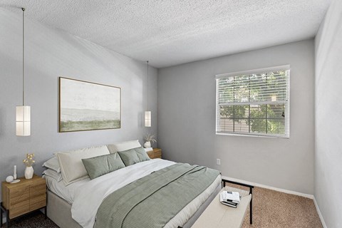 Three-Bedroom Affordable Apartments in Peachtree Corners, GA - Corners At 1700 - Bright Bedroom With Plush Bed, Pendant Lighting, Wood Nightstands, And A With Window Blinds.