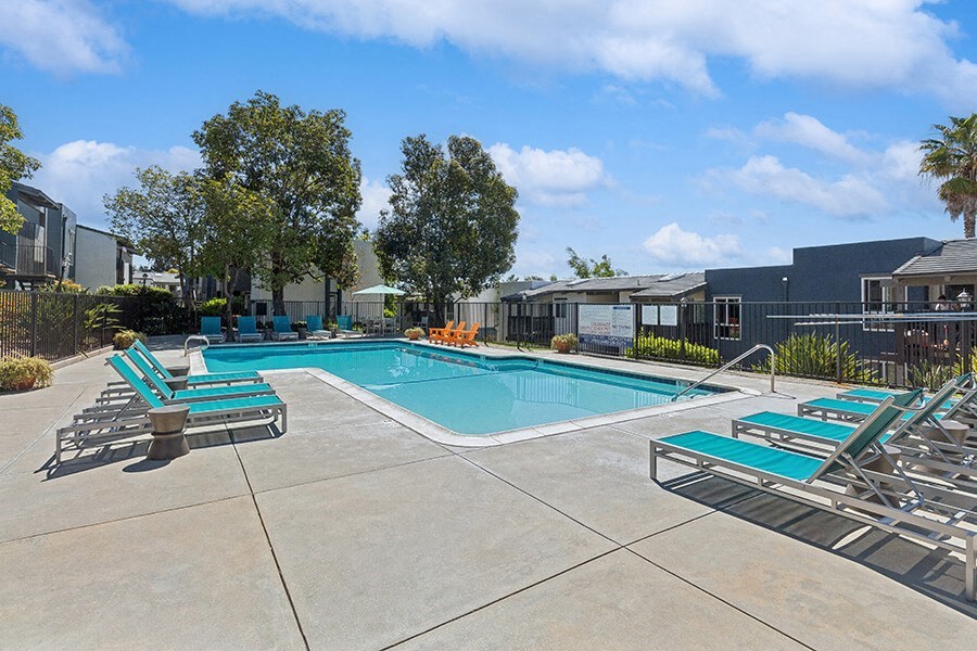 Community Swimming Pool with Pool Furniture at Colonnade at Fletcher Hills Apartments in El Cajon, CA.