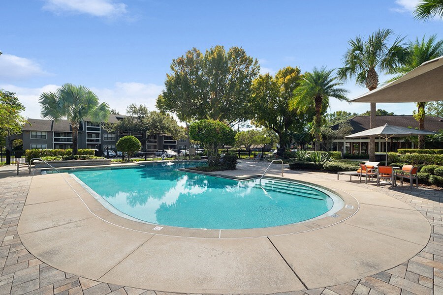 Community Swimming Pool with Pool Furniture at Fountains Lee Vista Apartments in Orlando, FL.