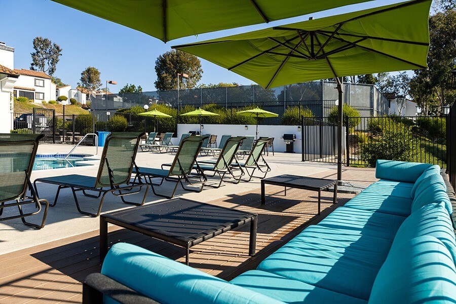 Community Swimming Pool with Pool Furniture at Santa Fe Ranch Apartments located in Carlsbad, CA.