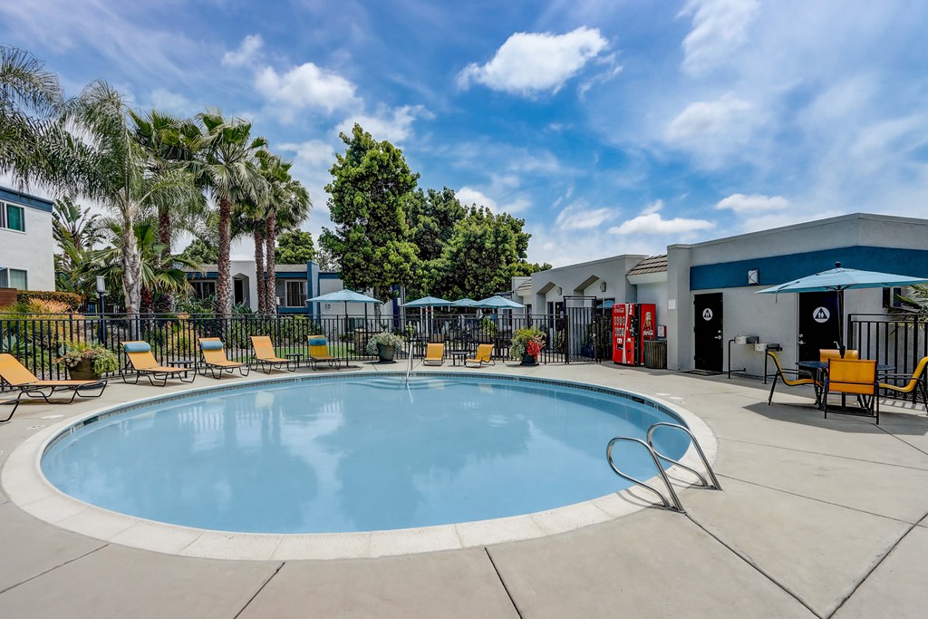 Community Swimming Pool with Pool Furniture at Cove La Mesa Apartments located in La Mesa, CA.