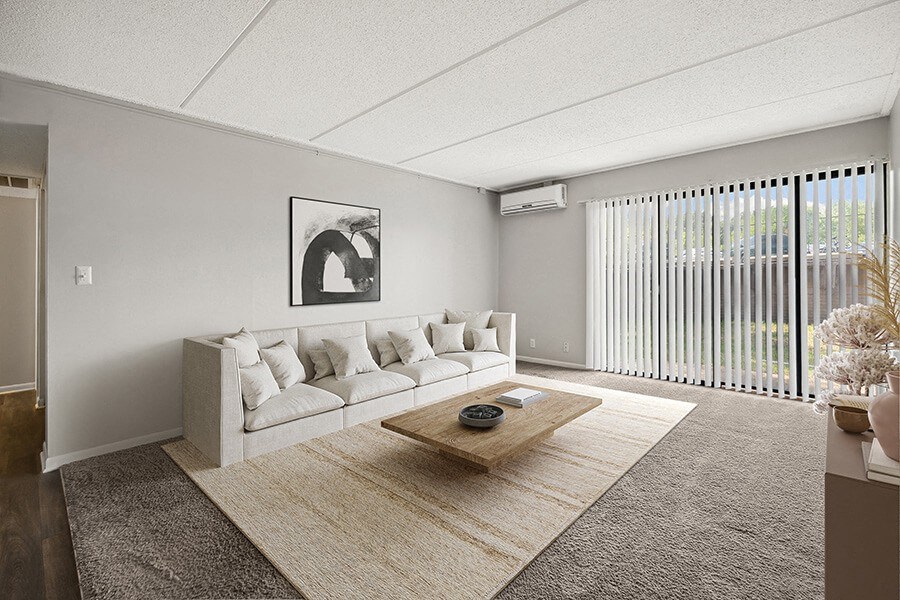 Model Living Room with Carpet and Patio Accessibility at Elevate on Parkway Apartments, Burnsville, MN
