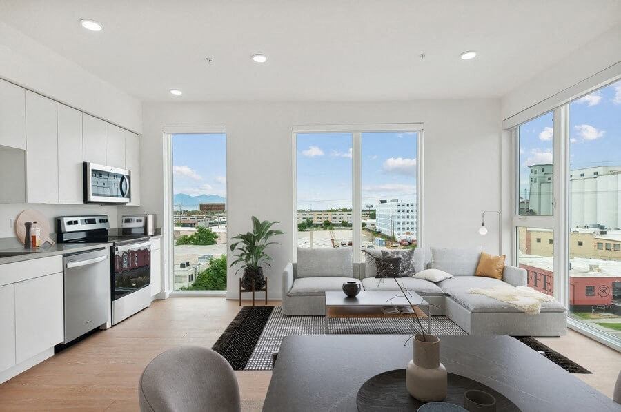 Model living room with large windows at 801 Flats located in Post District Residences in downtown Salt Lake City, Utah