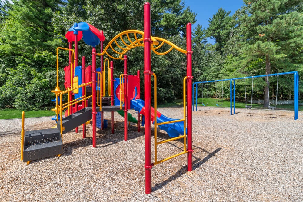 Community playground with trees in the background