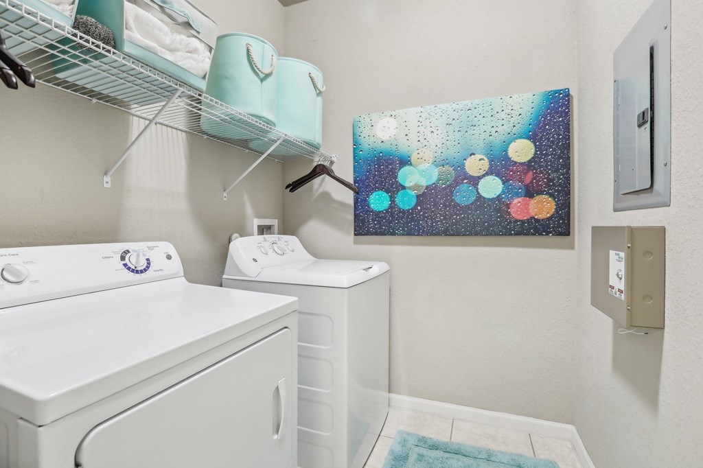 Model laundry room with a washer and dryer.