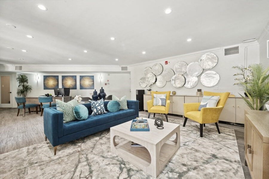 a living room with couches and chairs and a table