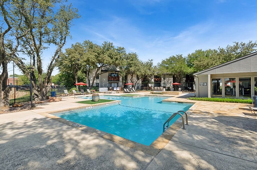Community Swimming Pool with Pool Furniture at Summit Ridge Apartments located in Arlington, TX.