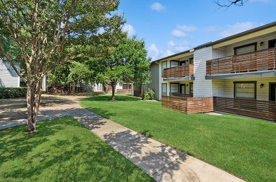 Exterior Community Building and Landscape at Woodcreek Apartments located in Arlington, TX.