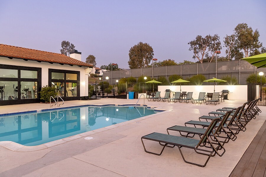 Community Swimming Pool with Pool Furniture at Santa Fe Ranch Apartments located in Carlsbad, CA.