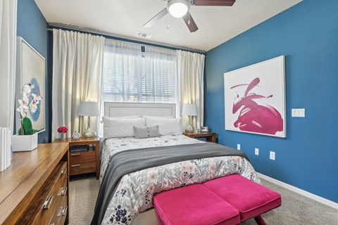 Model bedroom with blue accent wall.