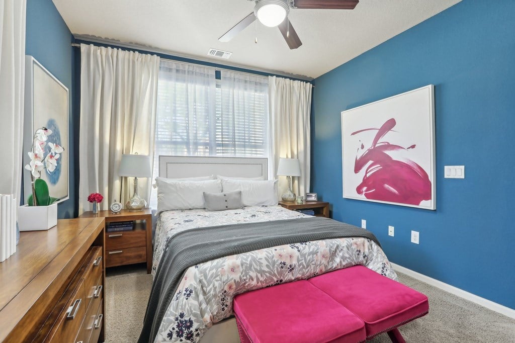 Model bedroom with blue accent wall.