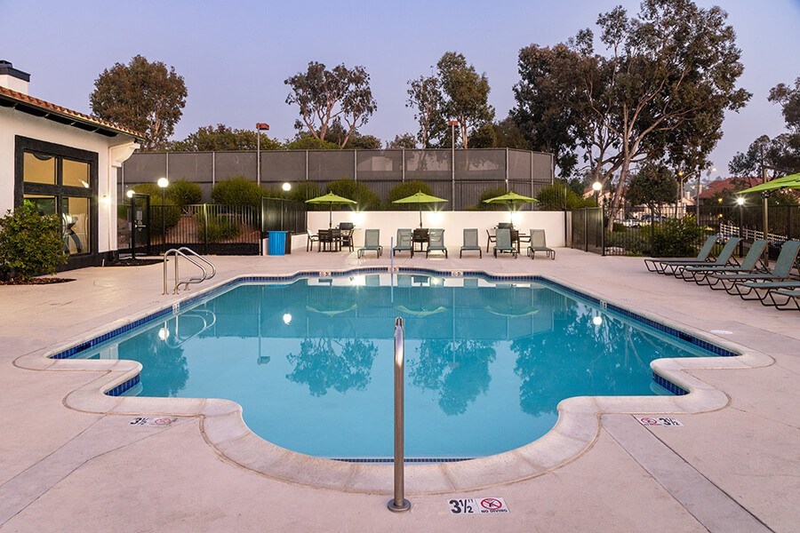 Community Swimming Pool with Pool Furniture at Santa Fe Ranch Apartments located in Carlsbad, CA.