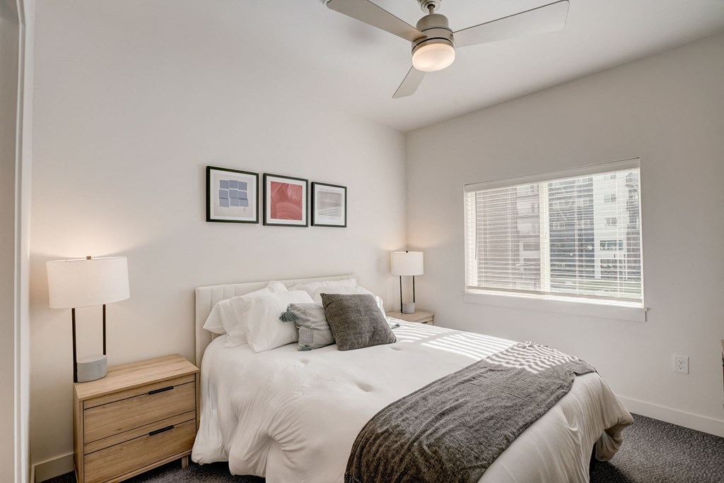 a bedroom with a large bed and a ceiling fan