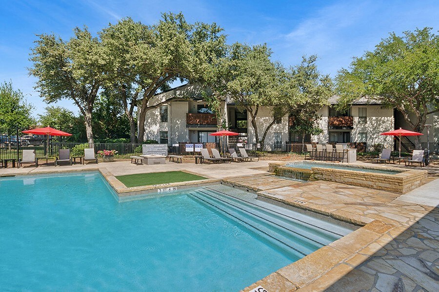 Community Swimming Pool with Pool Furniture at Summit Ridge Apartments located in Arlington, TX.