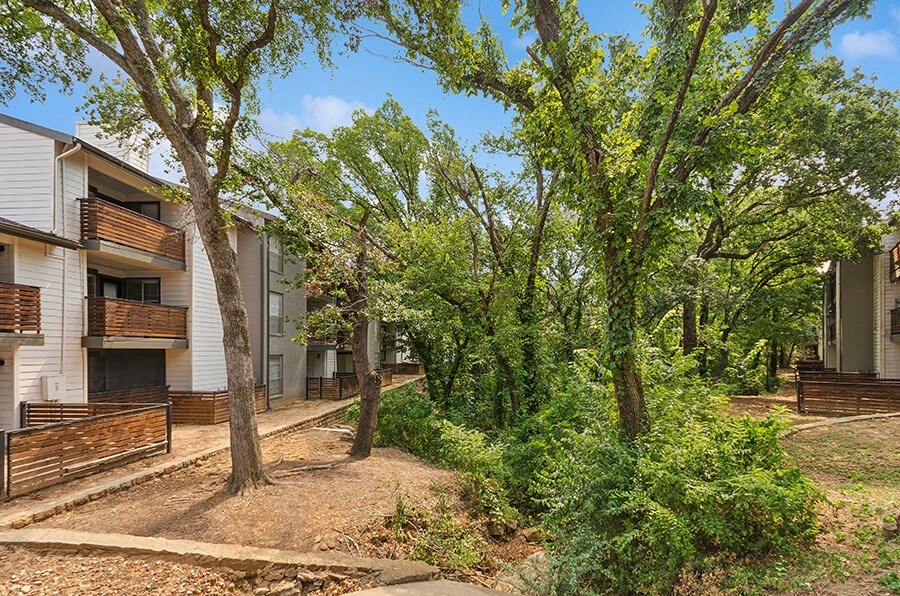 Exterior Community Building and Landscape at Woodcreek Apartments located in Arlington, TX.