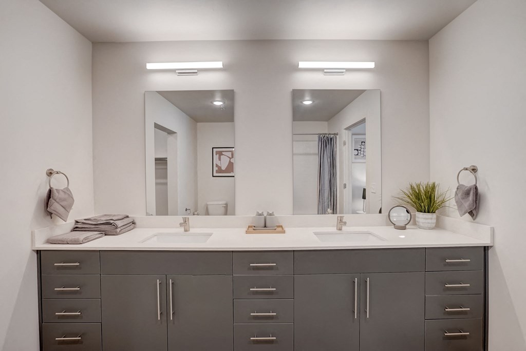 a large bathroom with two sinks and two mirrors