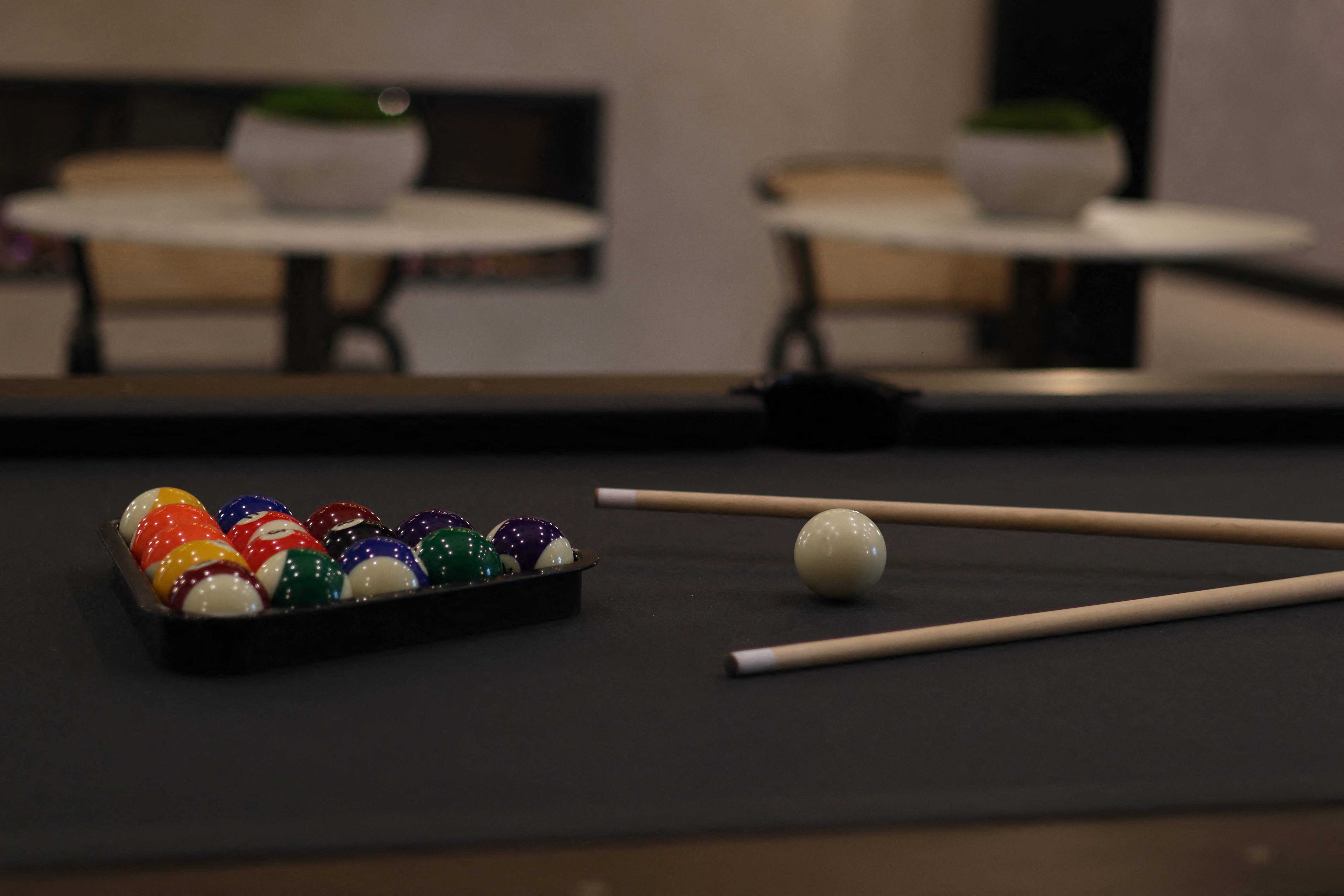 a pool table with balls and cues on it