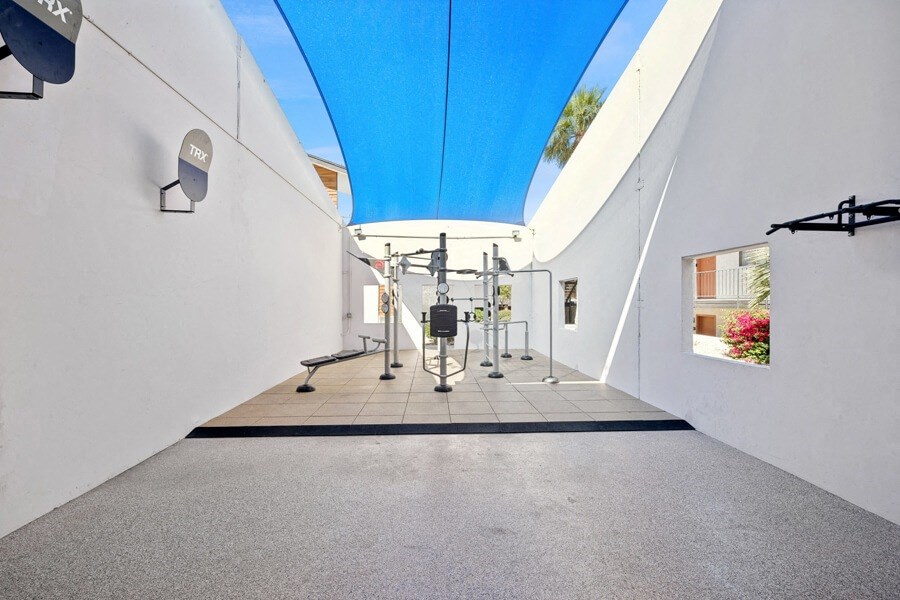 a gym with white walls and a blue ceiling