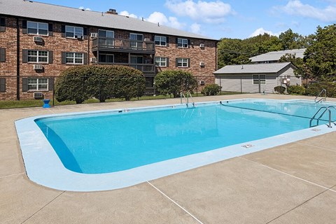 Community Swimming Pool with Pool Furniture at Middlesex Crossing Apartments located in Billerica, MA.