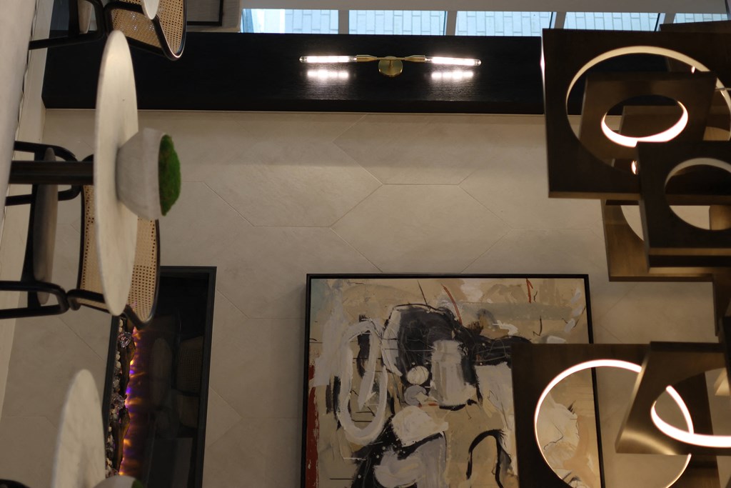 a view from above of an art gallery with paintings and lamps