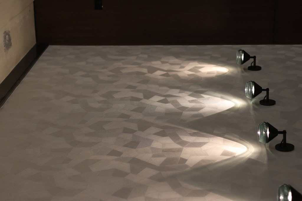 the floor is lit up at night with lights on it