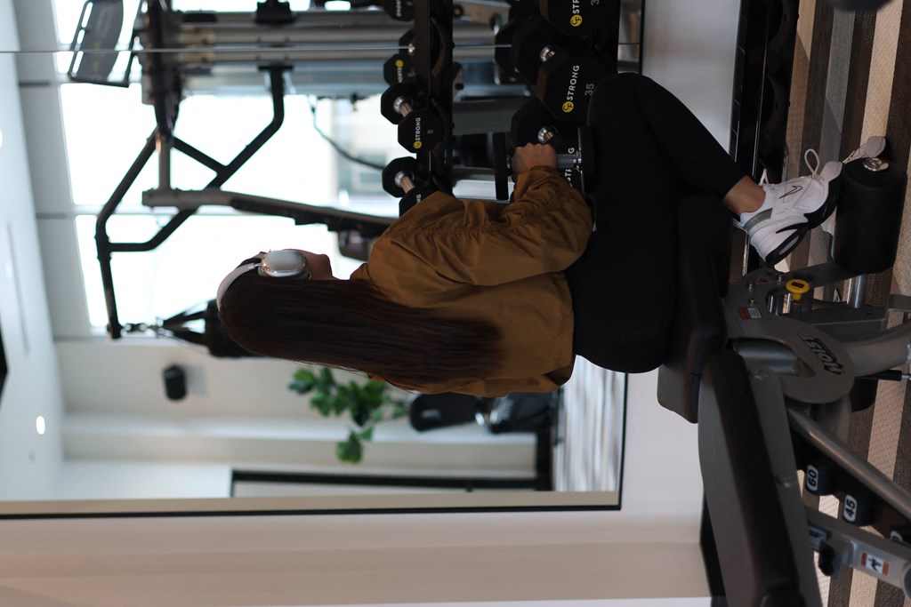 a man is hanging upside down on a ropes course on a gym swing
