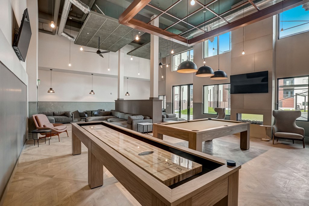 a view of a large room filled with wooden benches and chairs