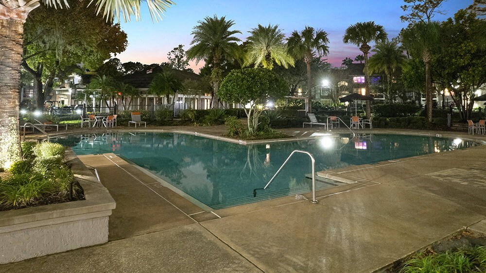 Community Swimming Pool with Pool Furniture at Fountains at Lee Vista Apartments in Orlando, FL.